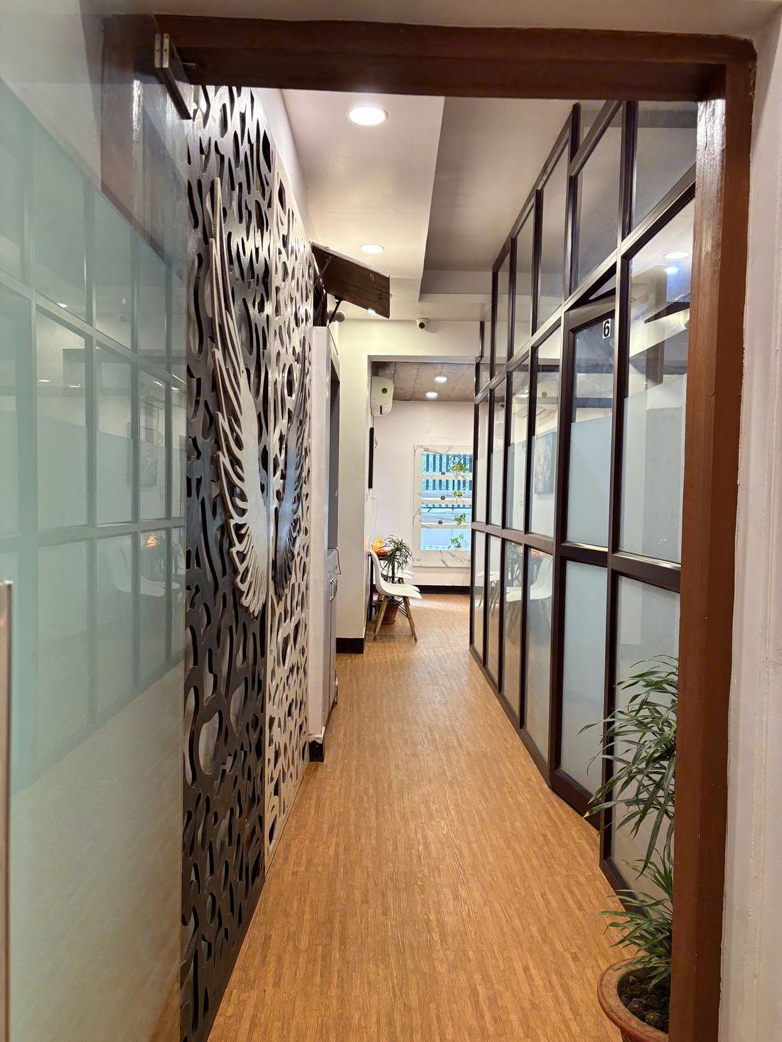 Corridor with glass partitioned cabins