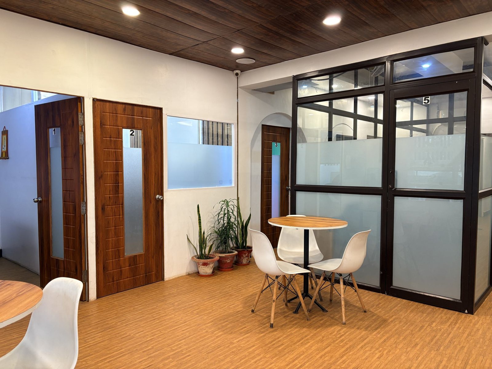 Interior of Prime Coworking with glass cabins and lounge seating