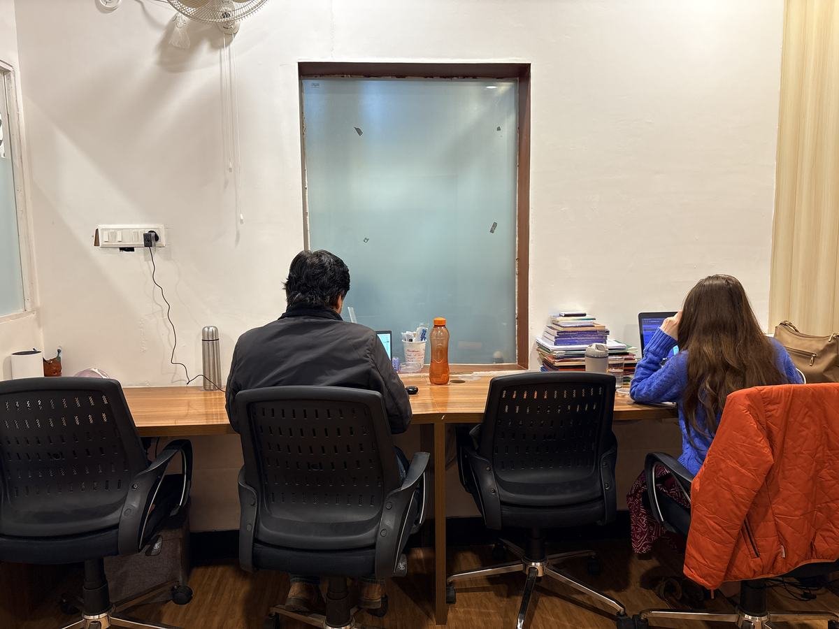 Dedicated desks with team members working