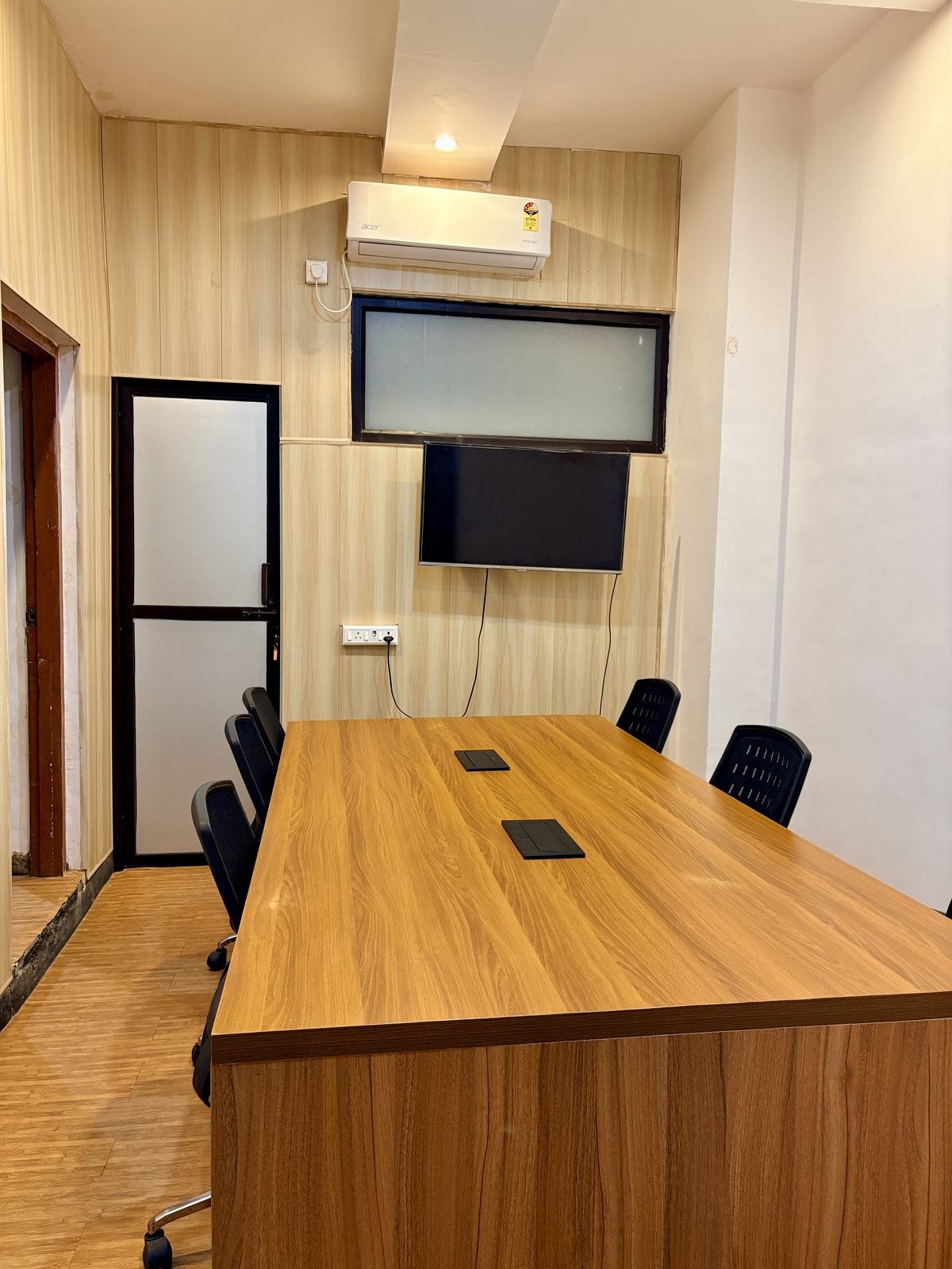 Meeting room with long table and wall screen